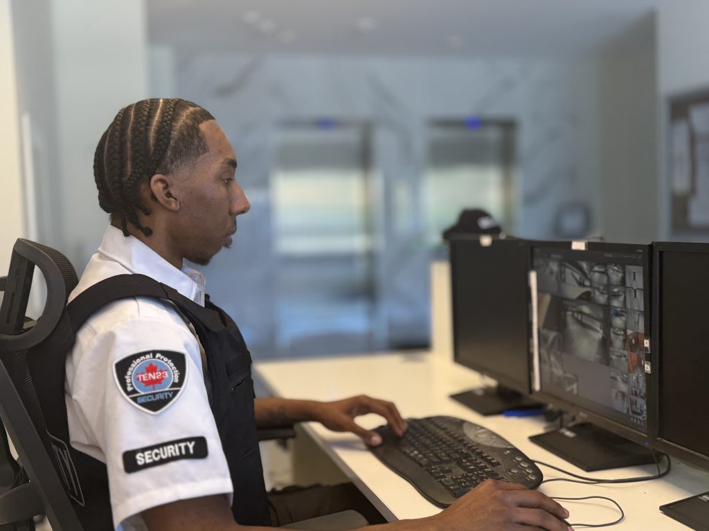 ten23security guard at desk monitoring cameras in waterloo